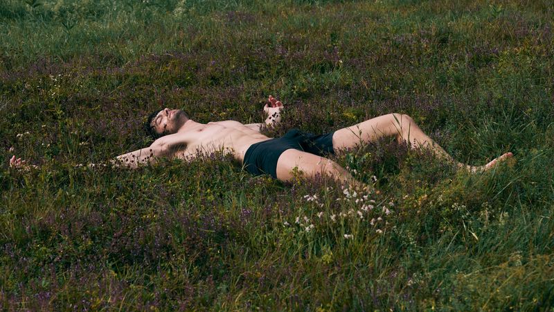 Image may contain: Grass, Plant, Back, Body Part, Person, Face, Head, Photography, Portrait, Field, Grassland, and Nature
