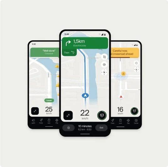 A set of three smartphone screens displaying the Cowboy app navigation interface. The center screen shows a route map with turn-by-turn directions, while the side screens display messages like “Well done” and “Careful now, a crossroad ahead,” along with speed and distance metrics.
