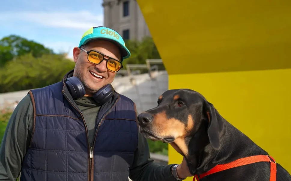 A man and dog in front of the museum