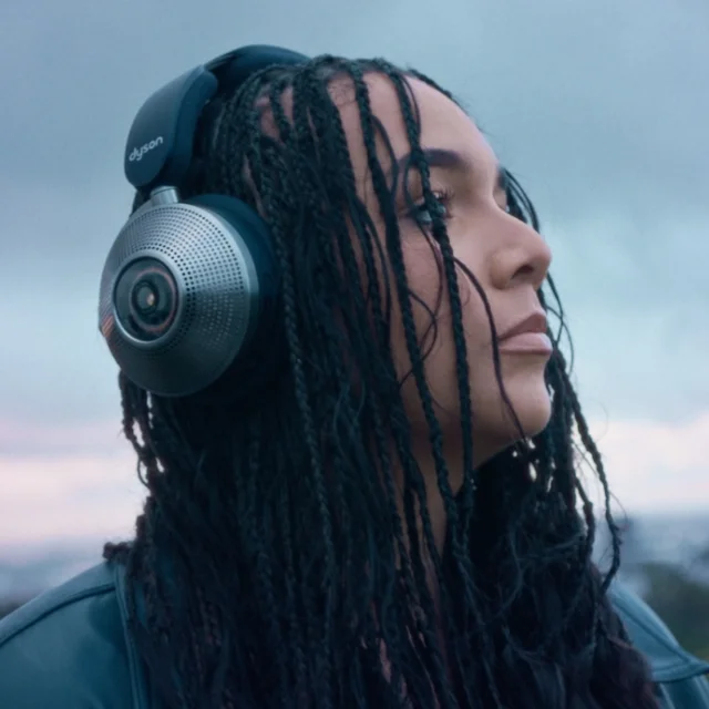 A woman outside wearing Dyson Zone™ noise cancelling headphones