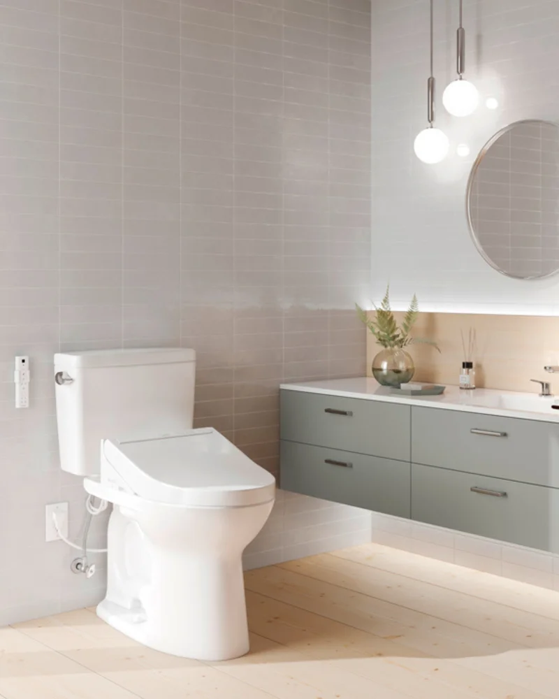 A TOTO Drake toilet with a C5 WASHLET attachment sits in a bright modern bathroom.