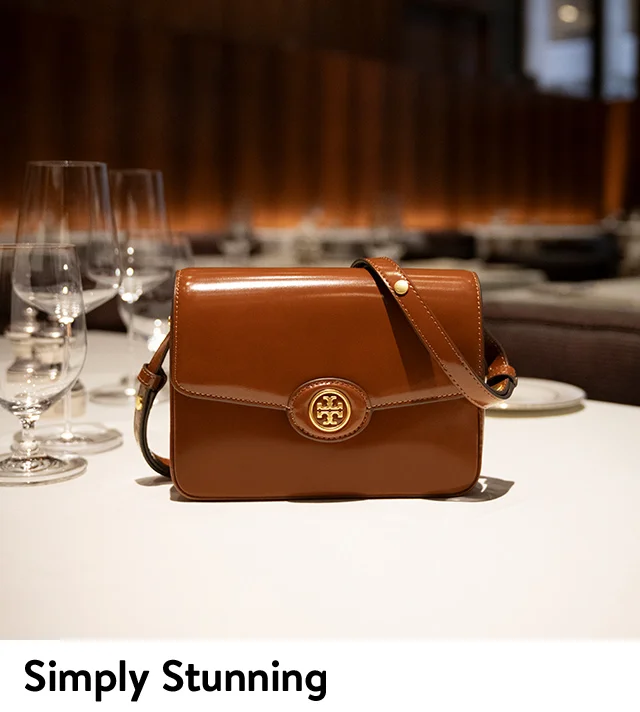 A brown leather Tory Burch shoulder bag with signature hardware.