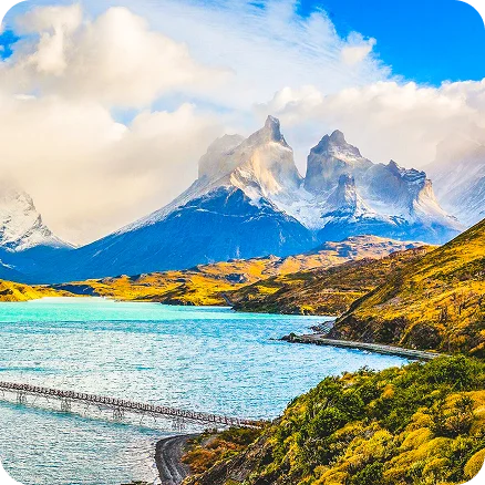 Image Description: A lake surrounded by hills and snowy mountains.