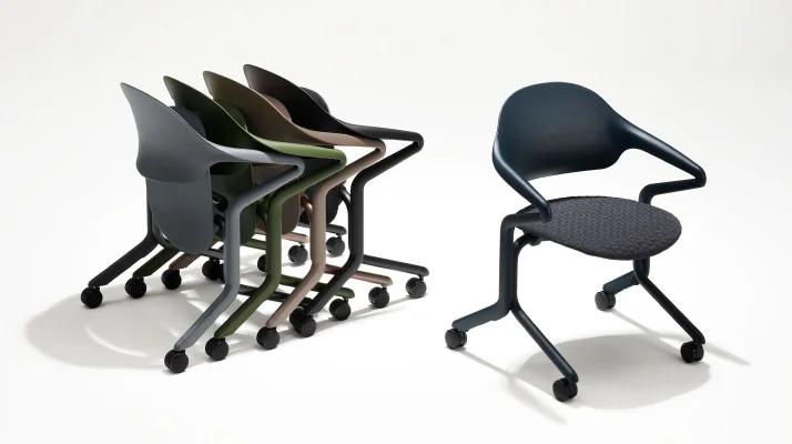 A group of four nested Fuld Chairs, all in different colors, next to an Olive Fuld Nesting Chair.