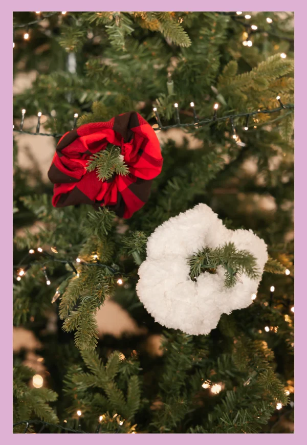 red and white scrunch hung on christmas tree with fairy lights
