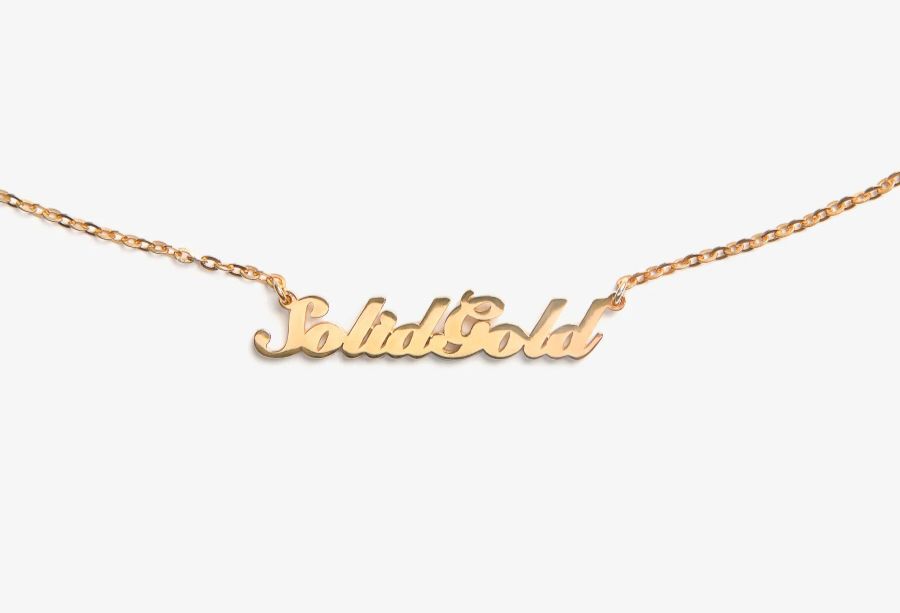 Gold necklace with the words “Solid Gold” in cursive