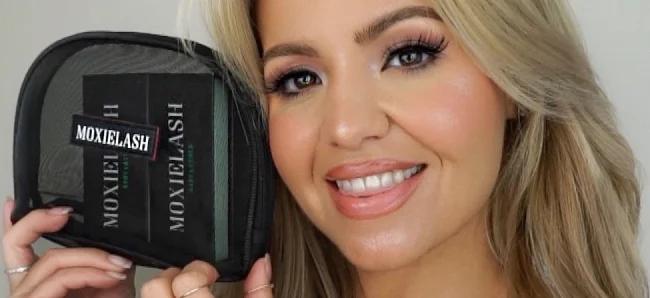 Image of a woman holding MoxieLash lash kit bag with bundled lash products
