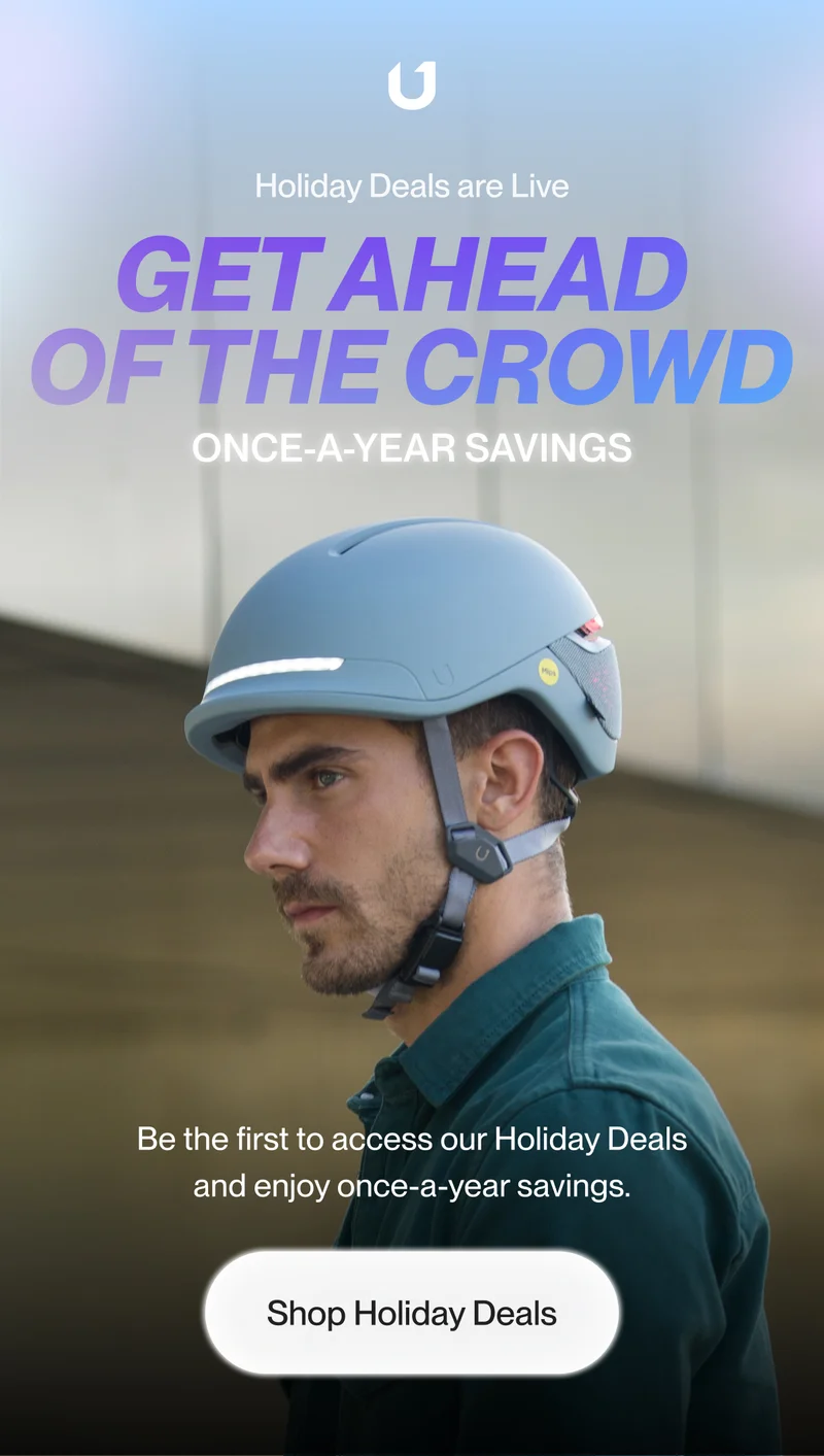 Man wearing a bike helmet with integrated lights.