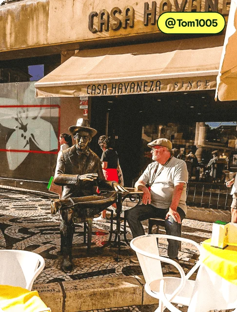 Image description: A person next to a seated bronze sculpture outside of Casa Havaneza, photo taken by @Tom1005.