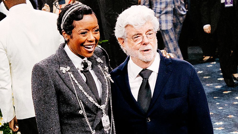 Image may contain: George Lucas, Tempestt Bledsoe, Person, Clothing, Footwear, Shoe, Accessories, Formal Wear, and Tie
