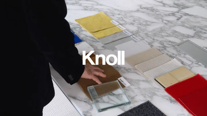 Hands sorting through textiles, Knoll logo in white in the center.