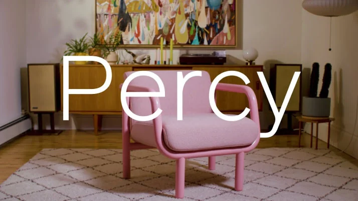 NaughtOne Percy Lounge Chair in pink upholstery with pink arms and legs sitting in the center of a living room setting.