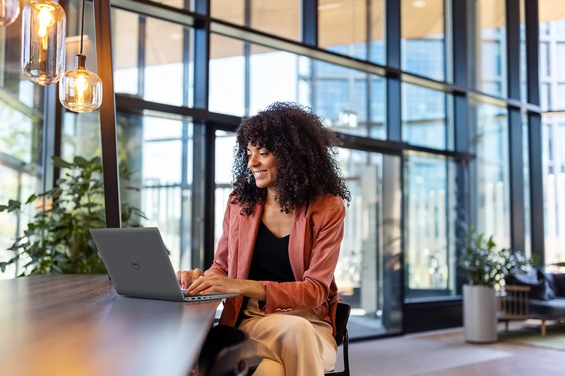 Young Woman Working from Laptop at Cafe