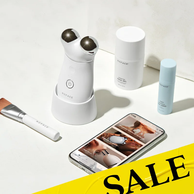 TRINITY+ Device in dock alongside Clean Sweep Brush, Hydrating Aqua Gel, Silk Crème Activator, and a smart phone showcasing the NuFACE Smart App.