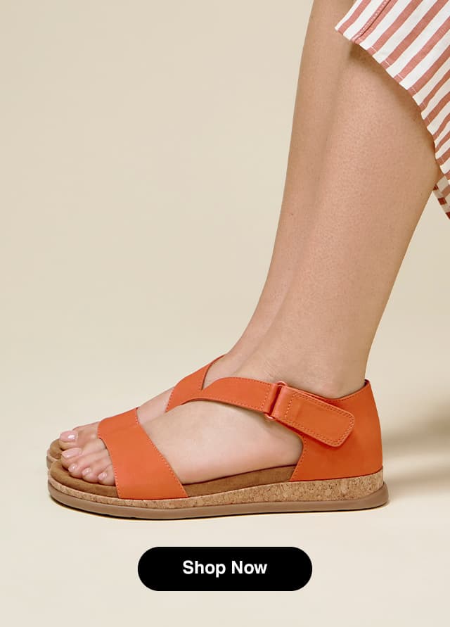A side view of the Rovie in Orange leather on foot.