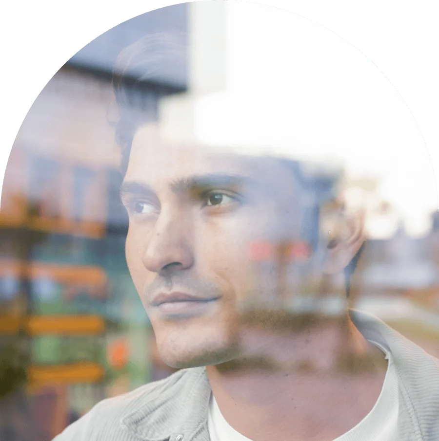 Young man looking through the window
