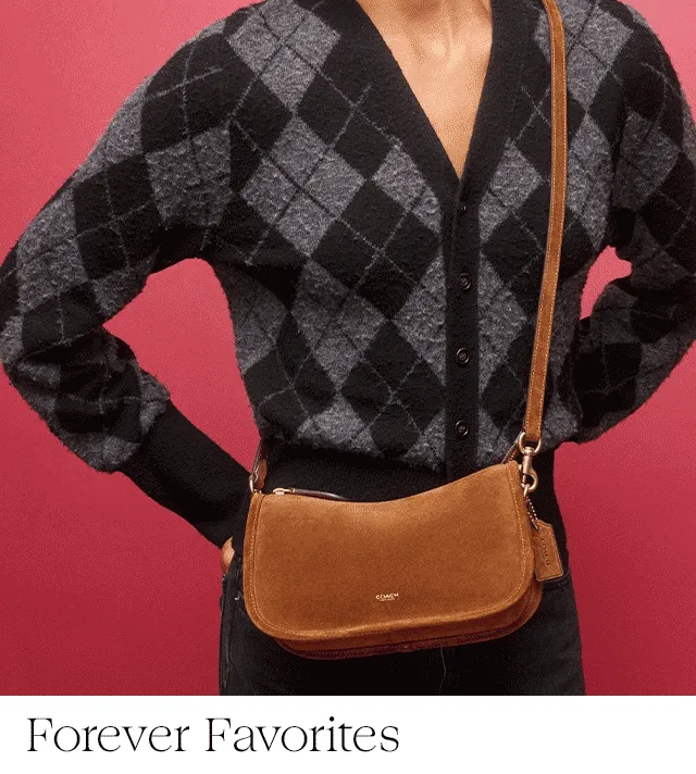 A woman wearing a small shoulder bag. Brown and black handbags.