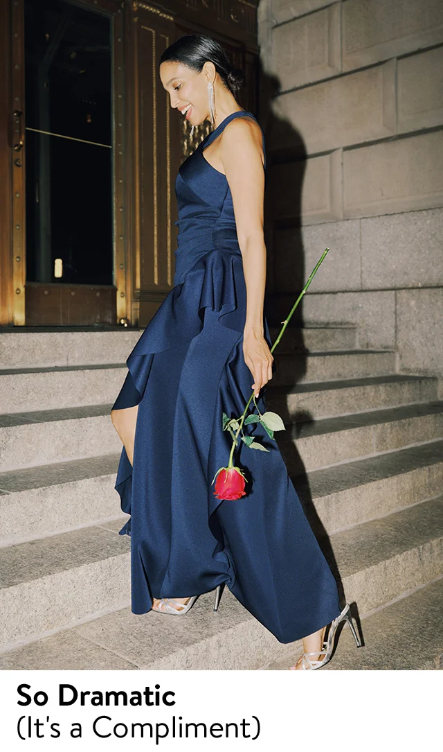 A woman wearing a dark blue ruffled gown.