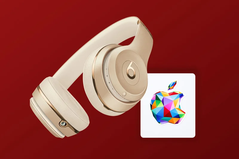 pair of Beats Solo3 Wireless headphones in gold with Apple Gift Card