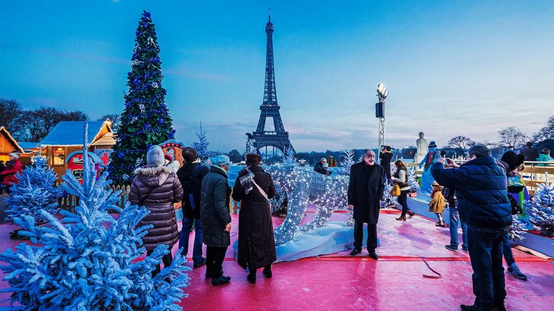 Image description: Tourists taking photos at the Christmas Village in Trocadéro, Paris