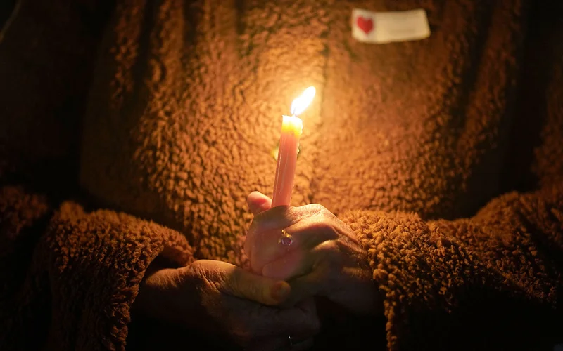 A woman attends a candlelight vigil for victims of the Half Moon Bay shootings in California in 2023.