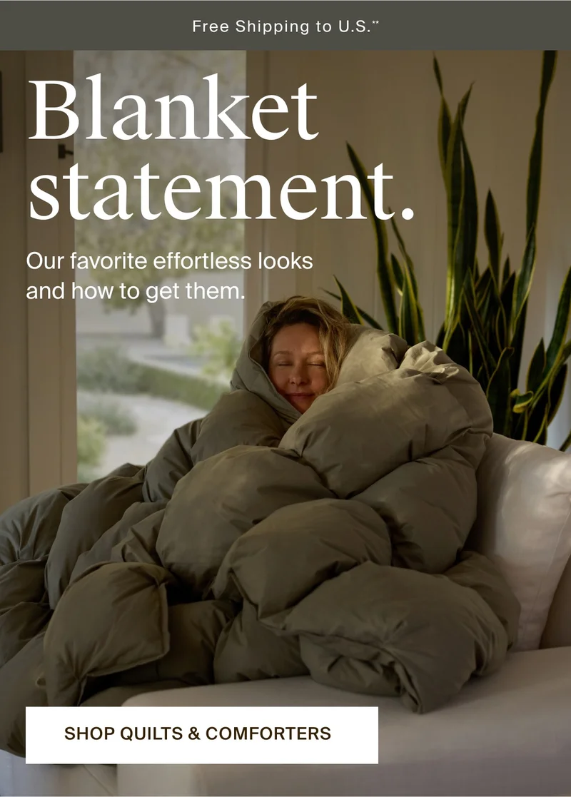 Woman wrapped in cozy comforter. Shop quilts & comforters