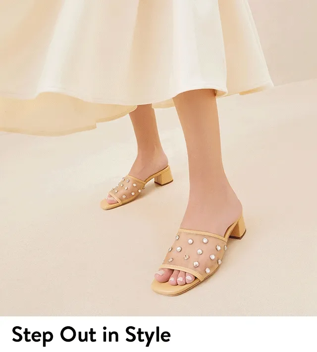 Women wearing heeled slide sandals from Loeffler Randall.