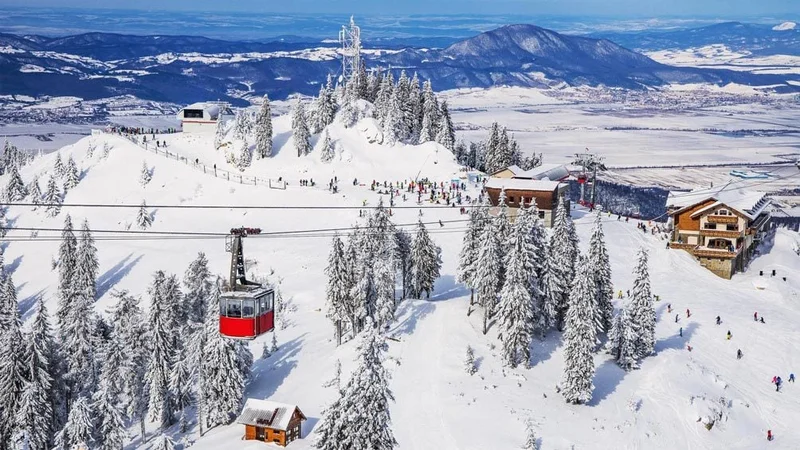 Image description: Panoramic view over the ski slopes with cable car ski lifts in Polana Brasov, Romania.