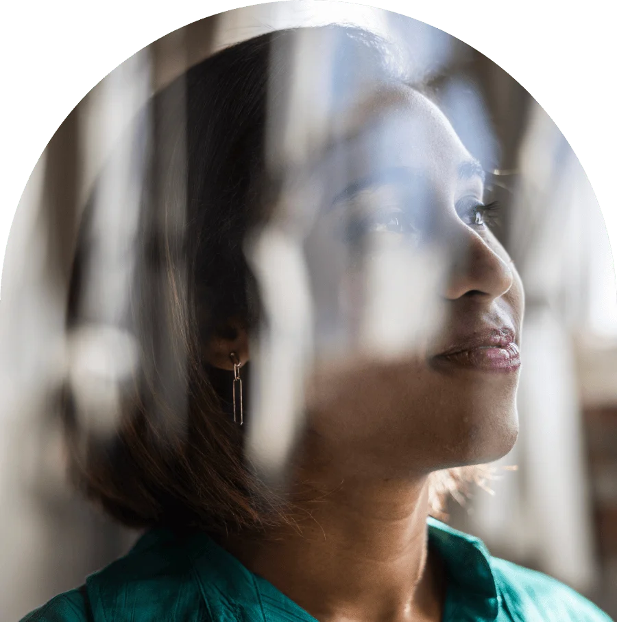 Portrait of female businesswoman reflecting in glass window