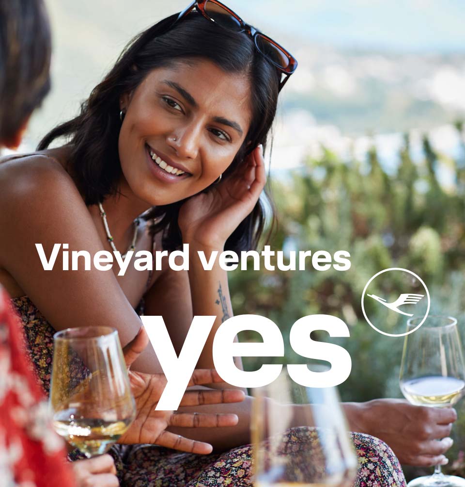 A cheerful conversation between friends in a vineyard.