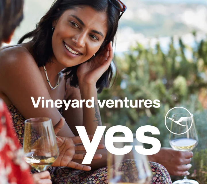 A cheerful conversation between friends in a vineyard.