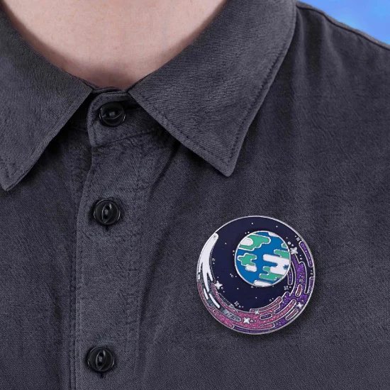 The Visiting Comet Pin pinned to a shirt