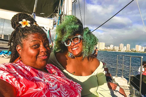 Image Description: Two people smiling on a boat.
