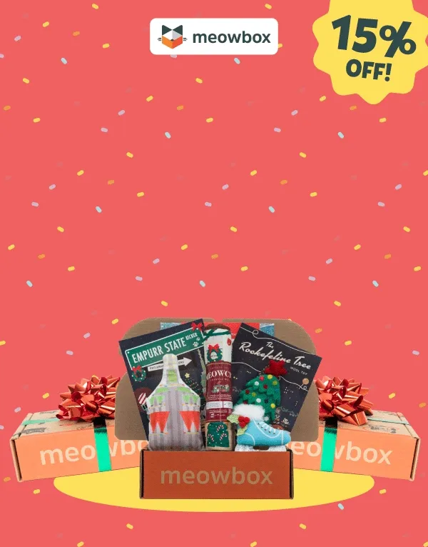 a box of christmas gifts with a drink and crackers on a red background