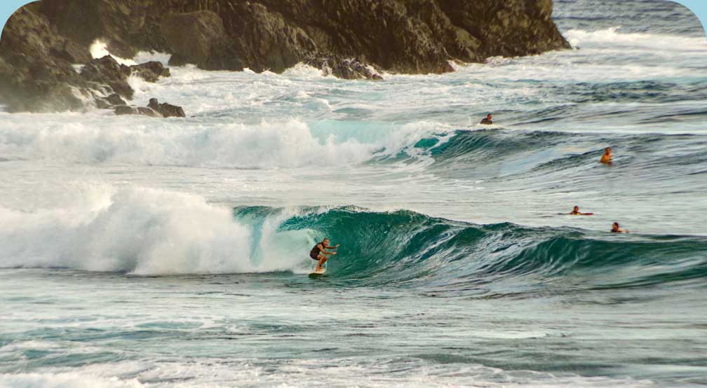 A person surfing a wave in the ocean.