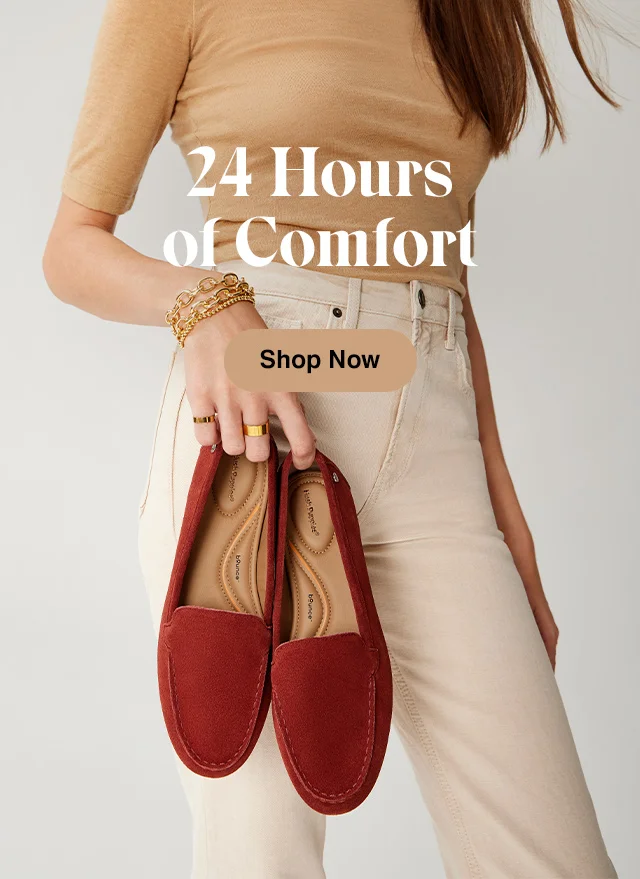 Woman holding the comfortable, flat Ozzie loafer in brick red suede. Shop Women's Shoes.