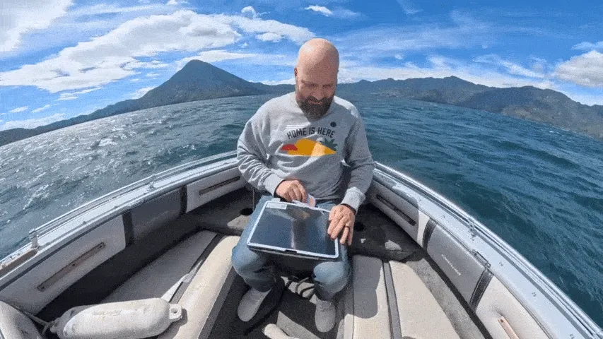 GIF of Jan applying the Paperlike 3 on a boat rocking in the water.