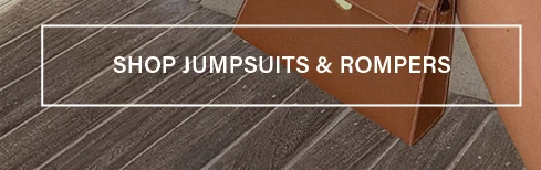 White "SHOP JUMPSUITS & ROMPERS" text box against a dark wood floor, inviting users to browse our latest jumpsuits and rompers.