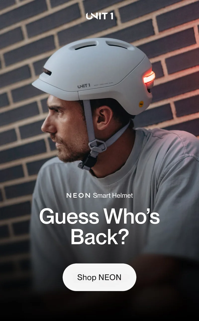 UNIT 1 NEON Smart Helmet hero image with rider wearing the helmet, headline “Guess Who’s Back?” and “Shop Now” button.