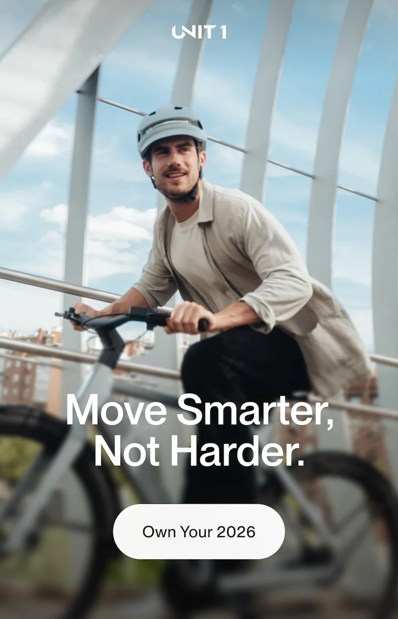 Man riding an e-bike wearing a UNIT 1 smart helmet with the message Move Smarter, Not Harder.
