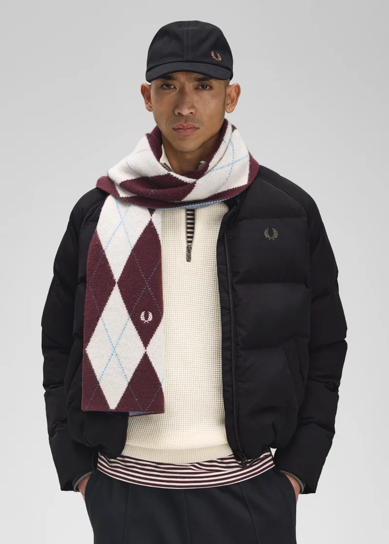 Male model wearing a Fred Perry Raglan Sleeve Padded Jacket in Black and an Argyle Scarf