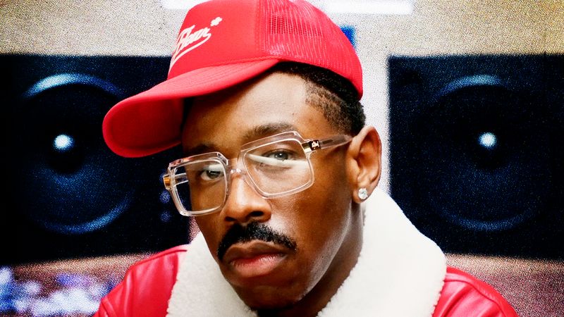 Image may contain: Tyler, The Creator, Baseball Cap, Cap, Clothing, Hat, Face, Head, Person, Photography, and Portrait