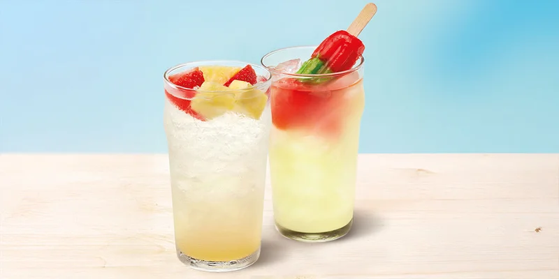 A photo of a Pineapple Splasher and the Watermelonade Cooler, which has an upside down popsicle in it.
