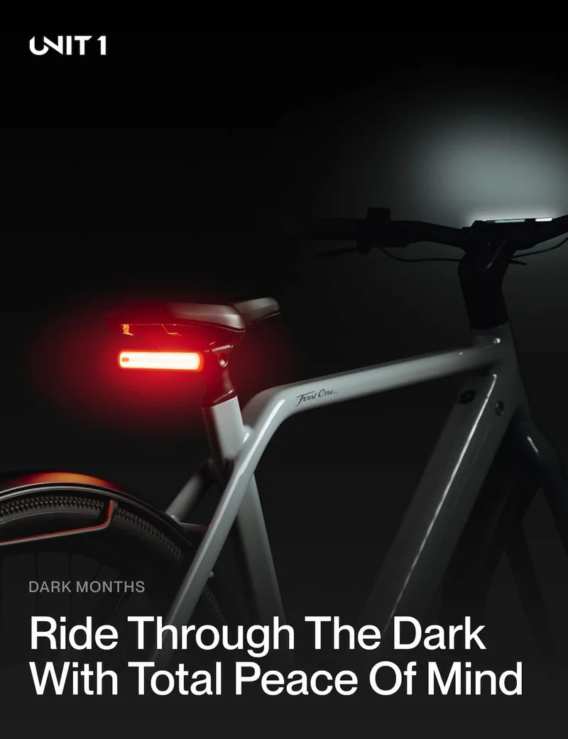 UNIT 1 Smart Light mounted under a bike saddle, glowing red to keep riders visible at night.