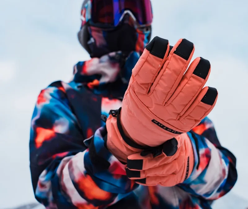 Close up of a model putting their Burton gloves one