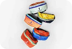 Rotating GIF of Festival branded Cotopaxi fanny packs in different colorways: green, red, navy blue.