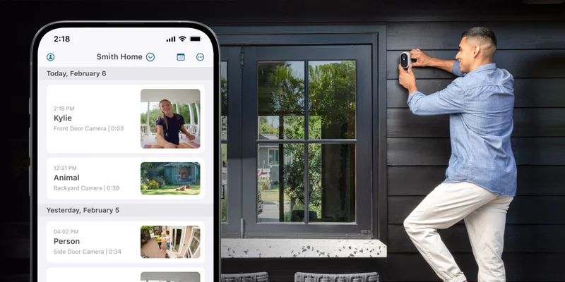 Person setting up an Arlo security camera. A phone with a simulated Arlo screen image displays an event feed in the Arlo Secure app.