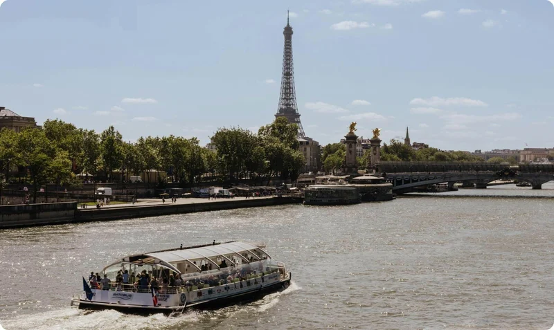 A boat approaches the Eiffel Tower on the Seine, Paris, France