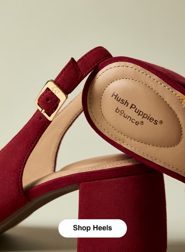 A close-up of the Movena Block-Heel Pump in Ruby suede highlighting the logo-detailed buckle and the cushioned insole. Shop Heels.
