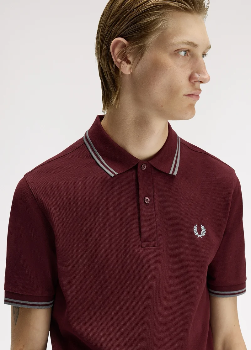 Model wearing a M3600 Fred Perry Shirt in Oxblood / Stockport Blue / Stockport Blue